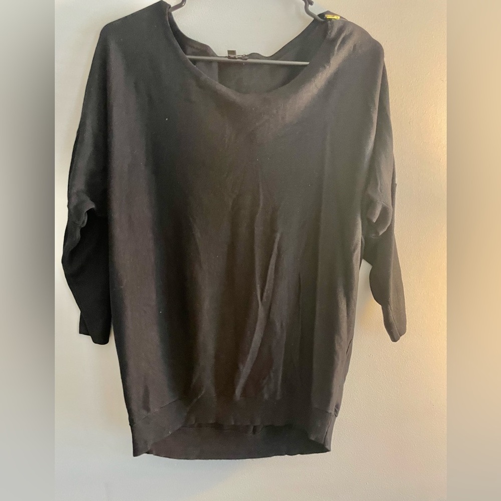 Black woman’s sweater with zipper on side of sleeve